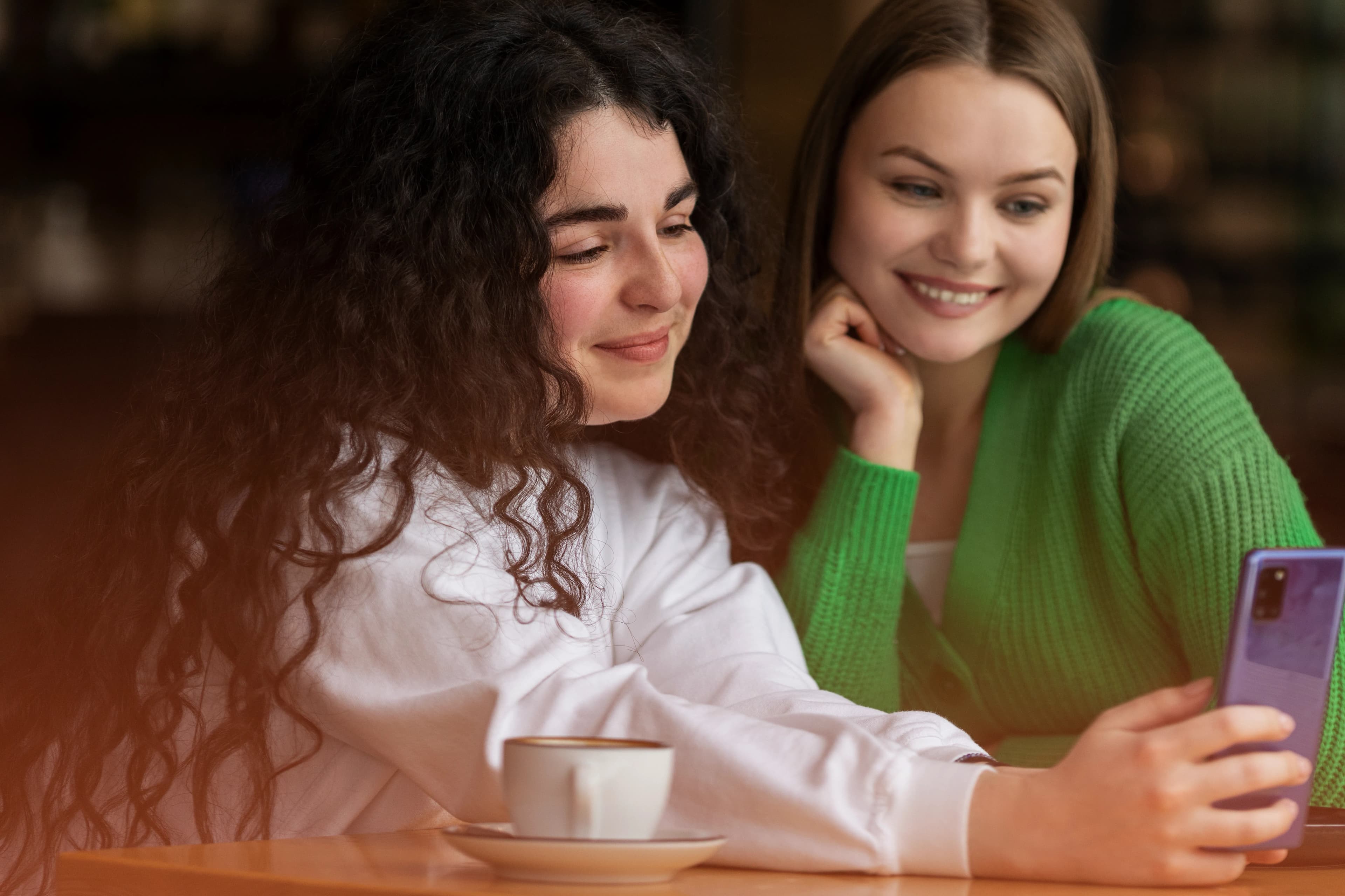 Friends laughing together over a smartphone